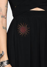 Black dress with a sun-shaped embroidered design on a plain background
