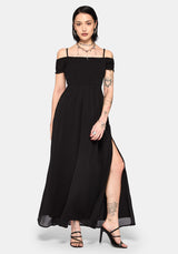 Woman wearing a black off-shoulder maxi dress with a thigh slit on a white background