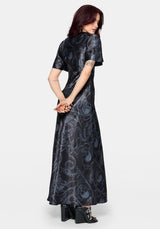 Woman wearing a black maxi satin snake printed dress on a white background
