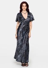 Woman wearing a black maxi satin snake printed dress on a white background