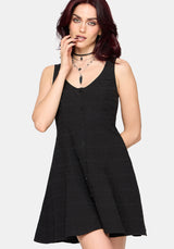 Woman wearing a black sleeveless dress on a white background