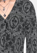 Close-up of a gray patterned cardigan with intricate designs.