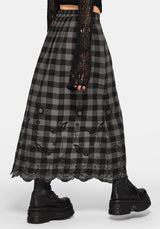Woman wearing a black and gray checkered skirt with lace details on a white background