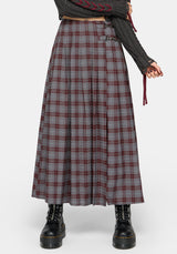 A model wearing a long, pleated plaid skirt in gray, burgundy, and white, styled with a dark gray knit sweater and black combat boots against a light gray studio background.
