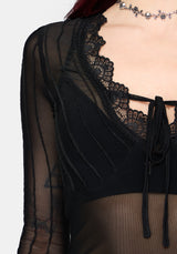 Black lace detail top with sheer sleeves on a white background