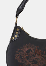Black handbag with brown embroidery and gold studs on a white background