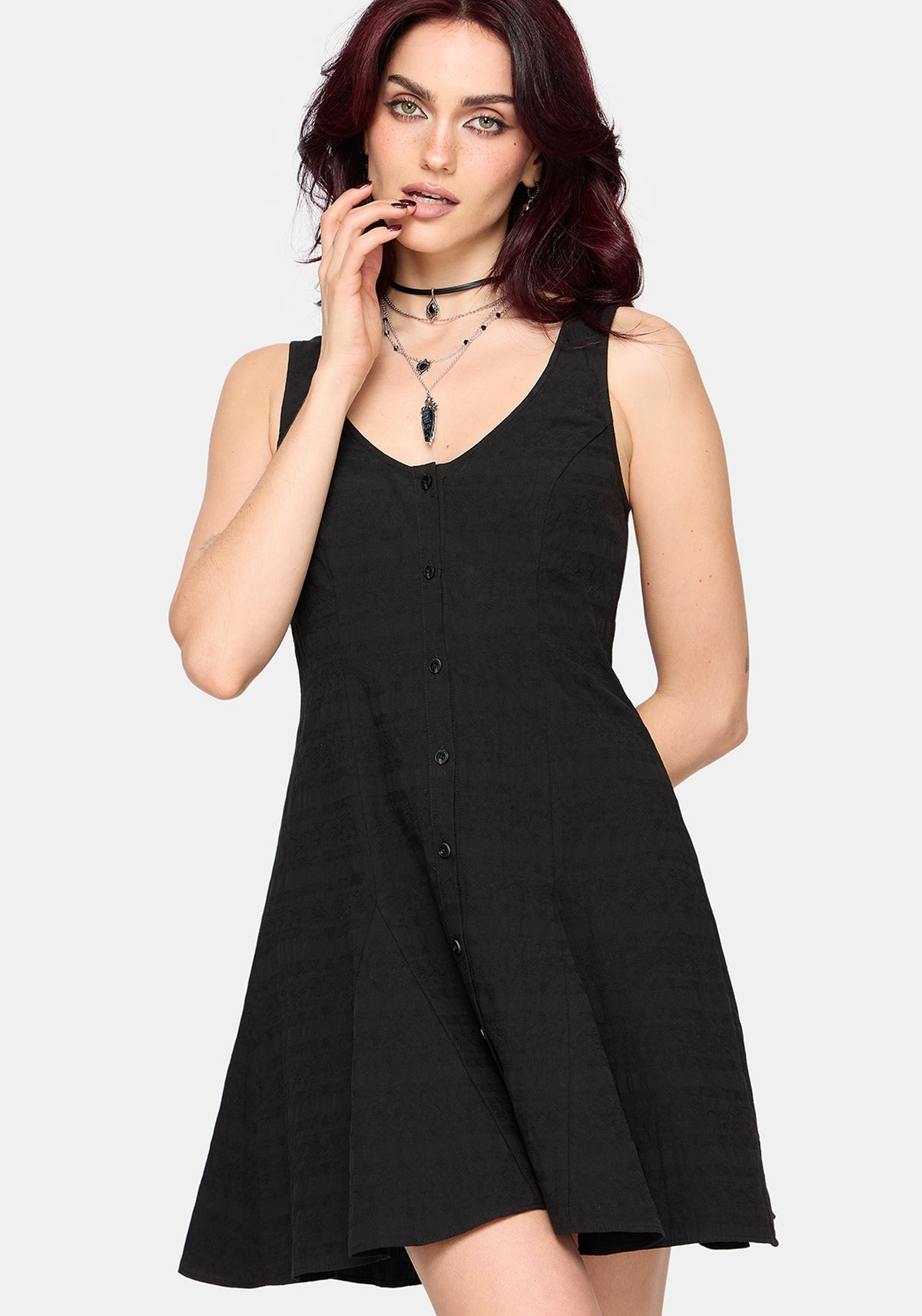 Woman wearing a black sleeveless dress on a white background