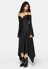A woman modeling a black off-the-shoulder long-sleeve midi dress with a high-low hemline, paired with black platform ankle boots, against a light gray studio background.