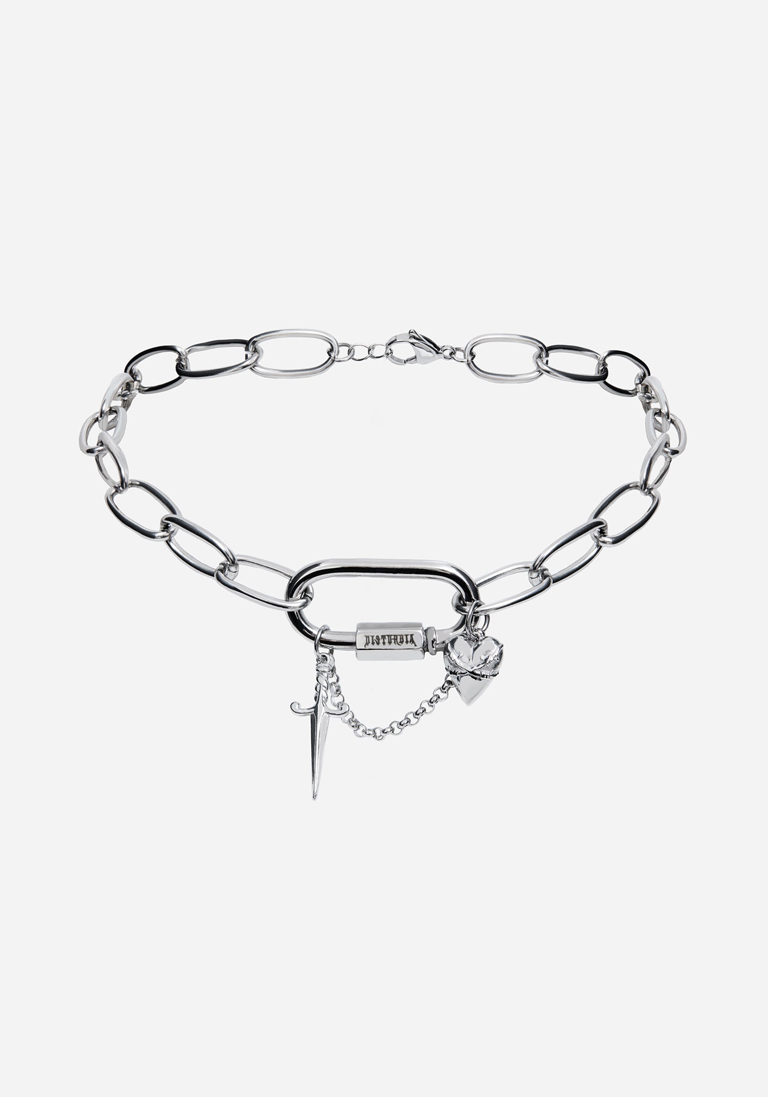 A close-up of a silver chain necklace with a large open rings and dangling cross charms
