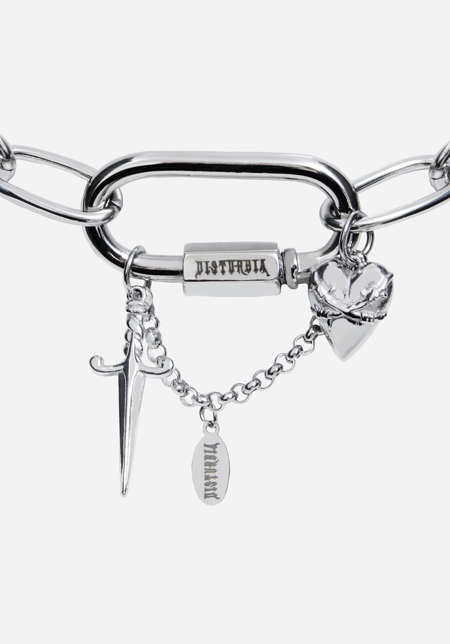 A silver-tone metal chain bracelet featuring a large open-link bar, a rectangular clasp engraved with 'DISTURBIA', and three dangling charms: a dagger, a broken heart, and a small oval tag.