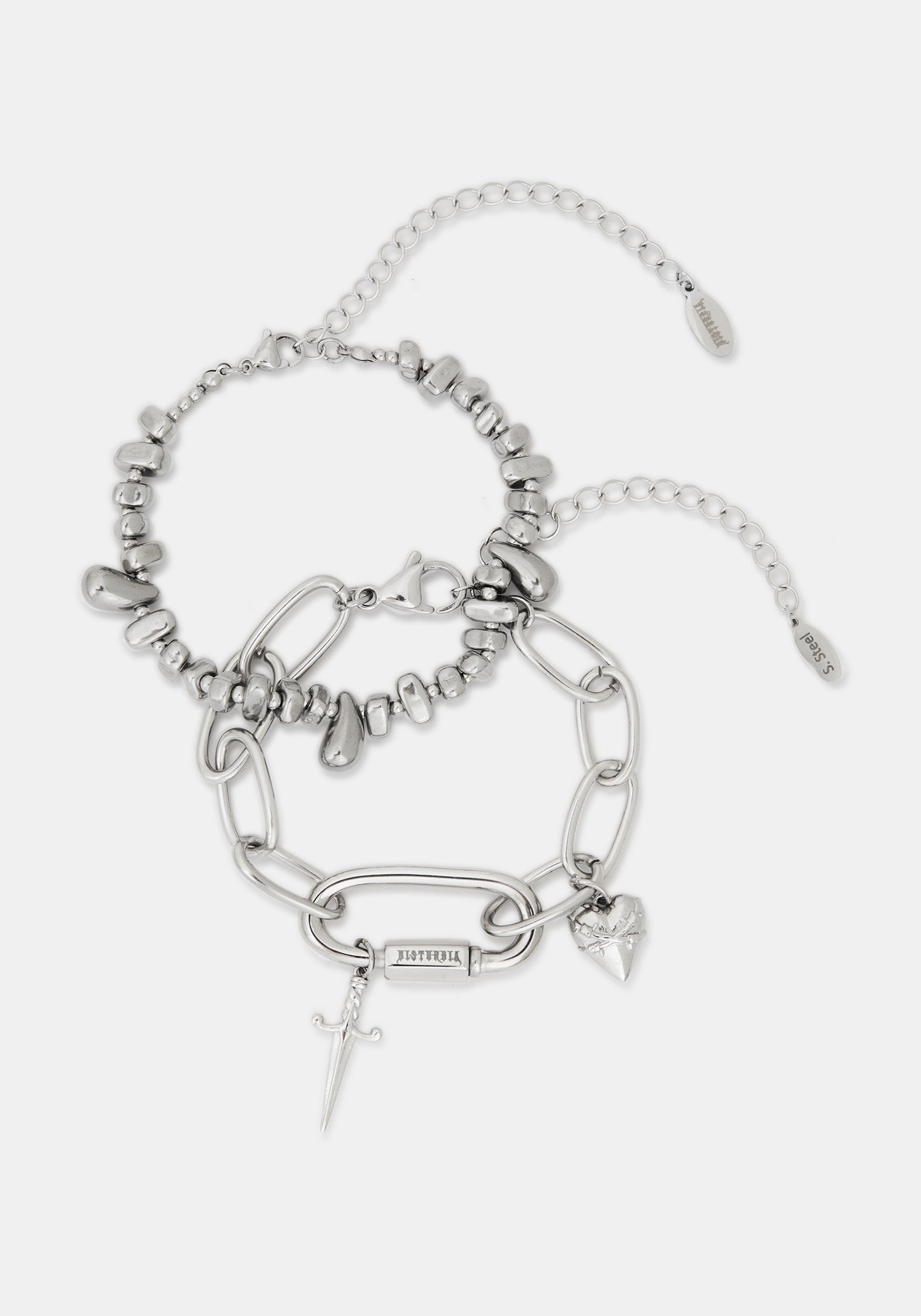 A stack of two silver-toned chain bracelets with charms, including a small sword, heart, and lock charms, displayed on a light gray background.