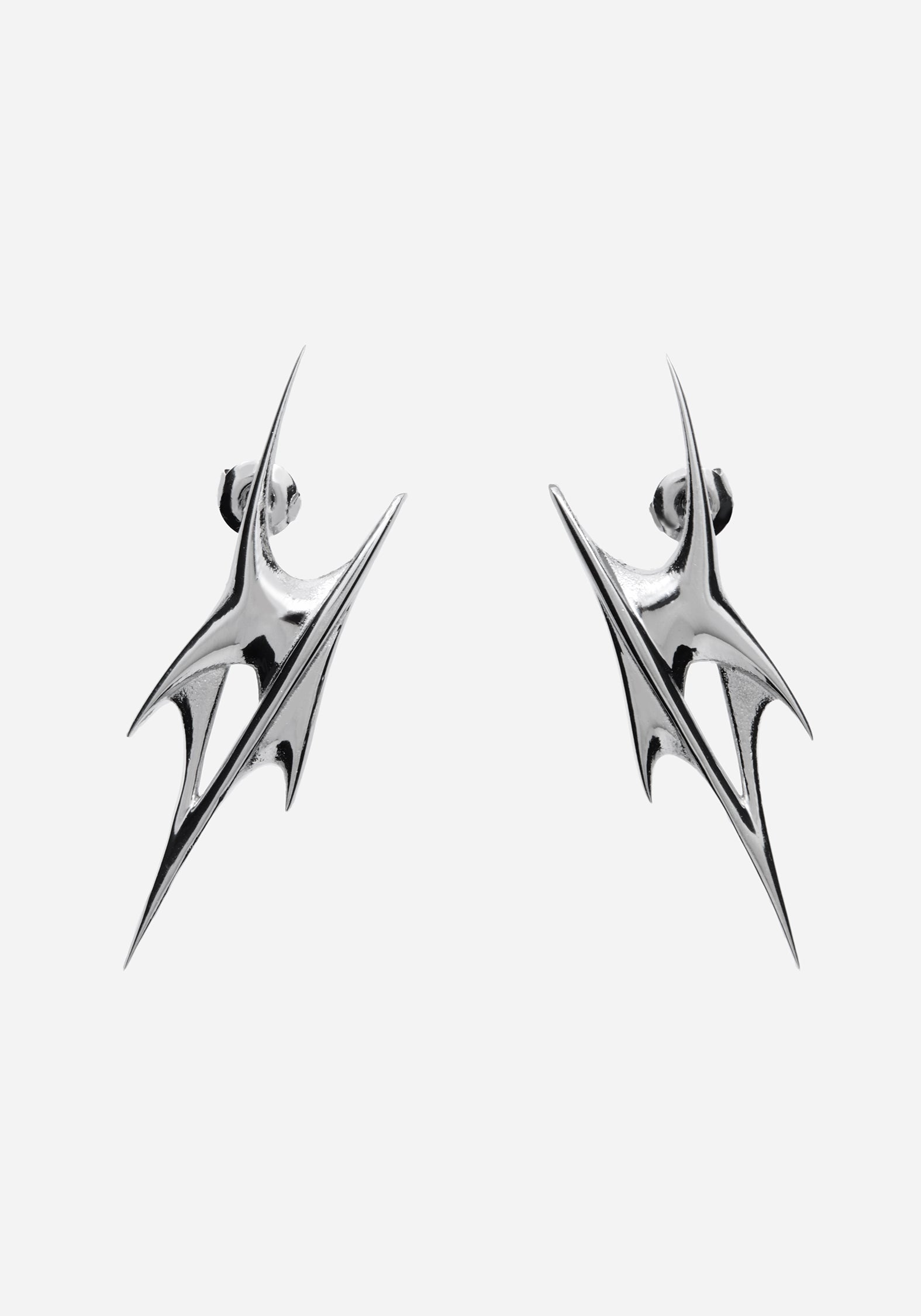 A pair of silver-toned geometric drop earrings with a sharp, angular spike design, shown against a plain light gray background.