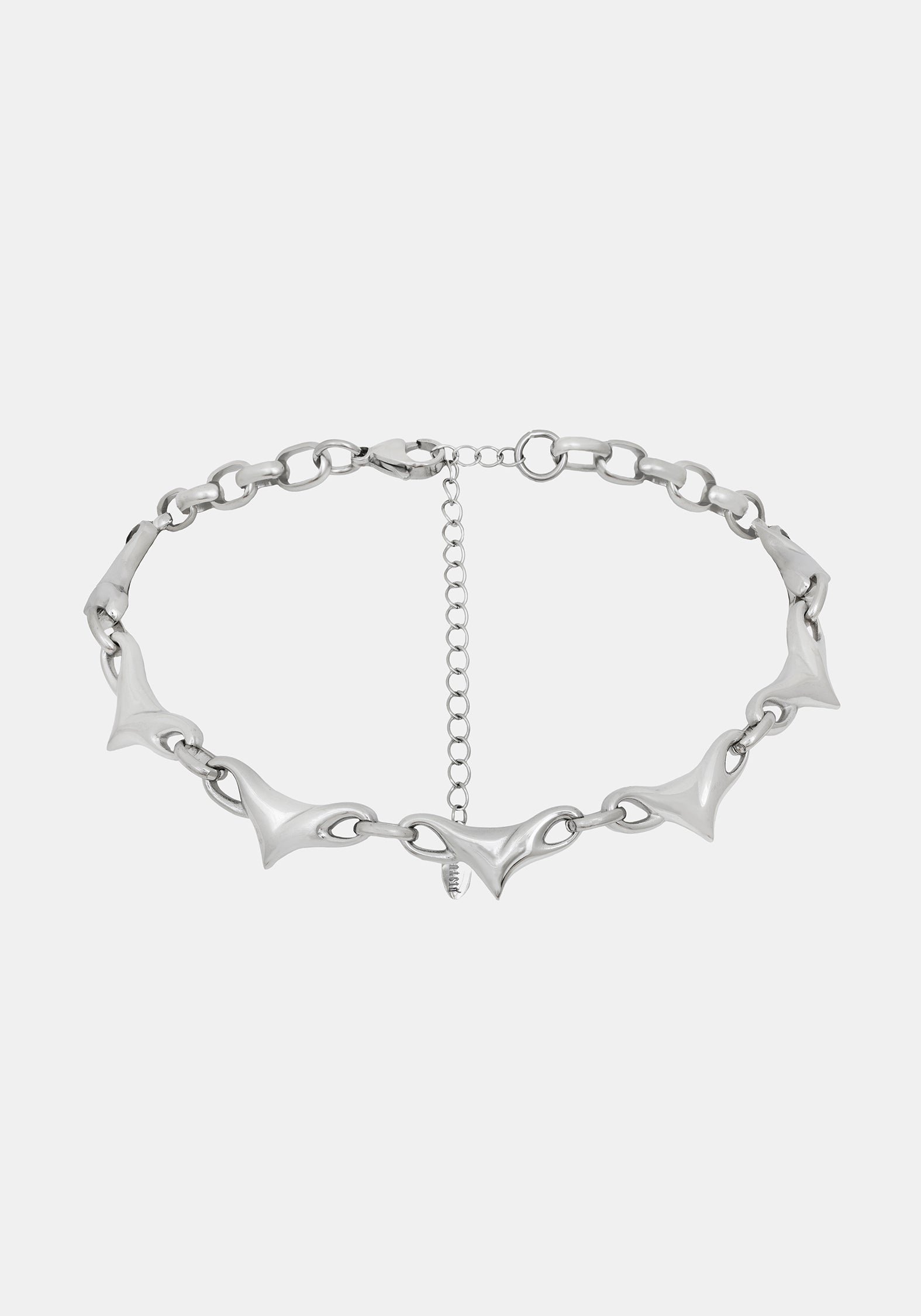 A silver-toned chain necklace featuring elongated, pointed spike links and a central extender chain, shown against a light gray background.