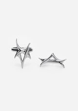 Close up two silver rings with a spike design against a white studio backdrop