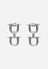 A pair of silver-toned U-shaped hoop earrings with sharp spike details on the front, shown against a plain light gray background.