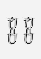 A pair of silver-toned chain-link drop earrings with small spikes at the top and bottom, shown on a light gray background.