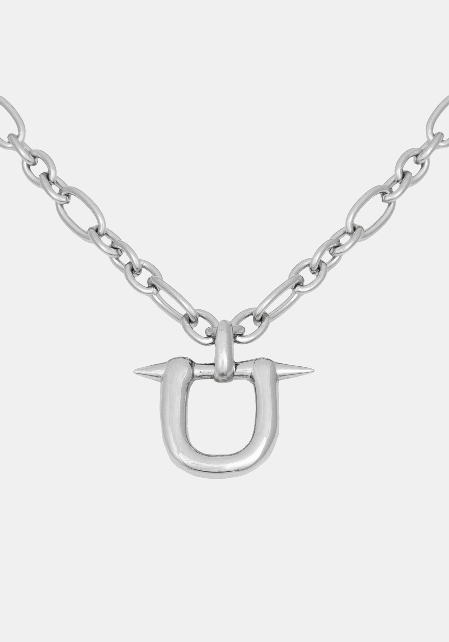 A silver-toned metal necklace featuring a U-shaped pendant with two sharp spikes extending from the top, suspended from a chunky link chain against a light gray background.
